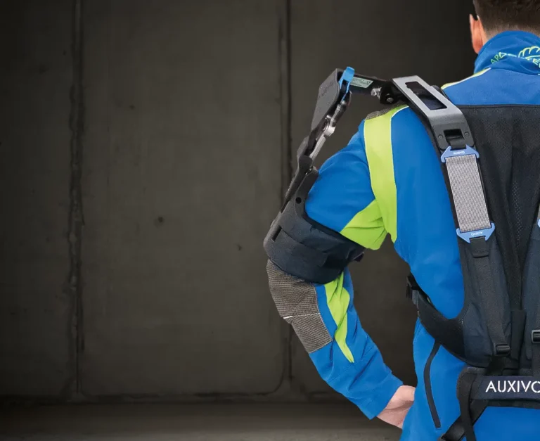 Mann von hinten in Forstkleidung mit Exoskelett